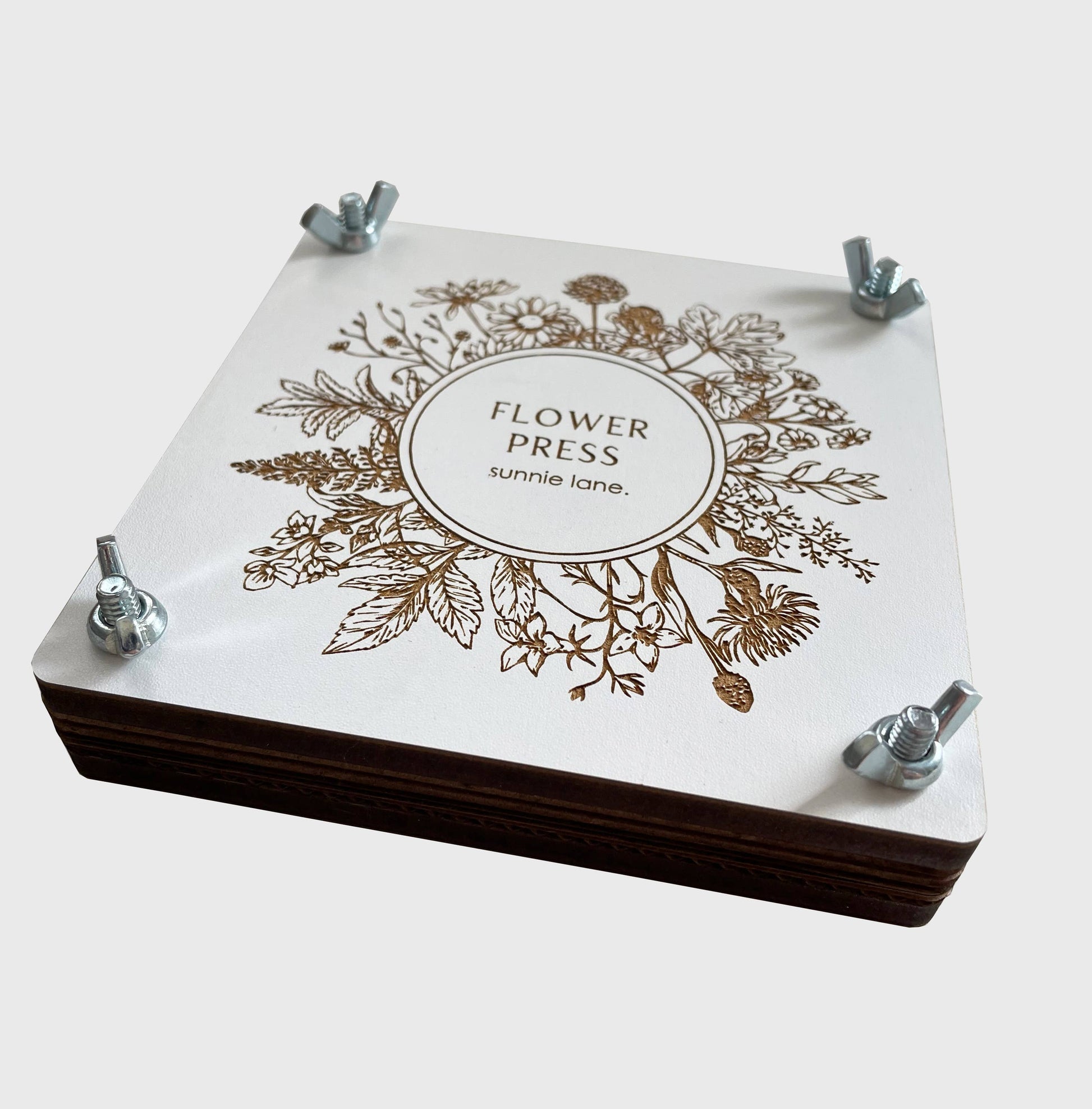 Flower press with floral design and 'Flower Press' text on a white background
