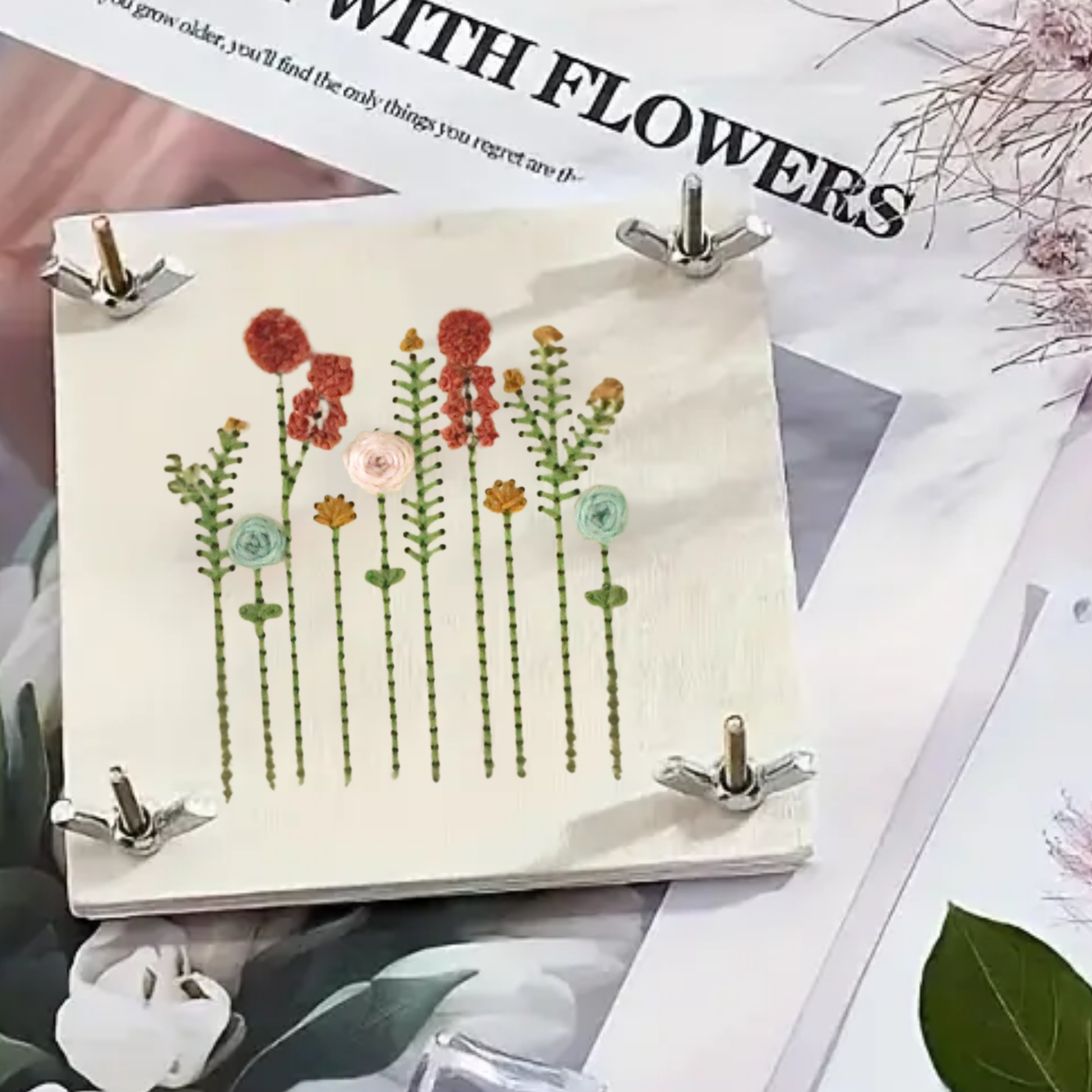 Floral illustration on a small board with a magazine underneath