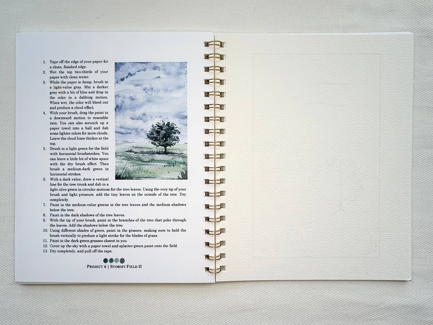 Open book with text and a tree illustration on a white background