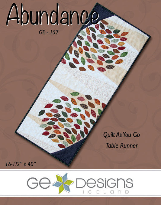 Table runner with autumn leaf pattern on a brown background, featuring GE Designs Iceland branding.