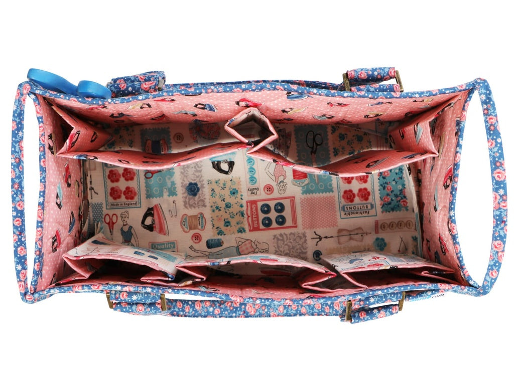Open pink and blue patterned bag with compartments on a white background