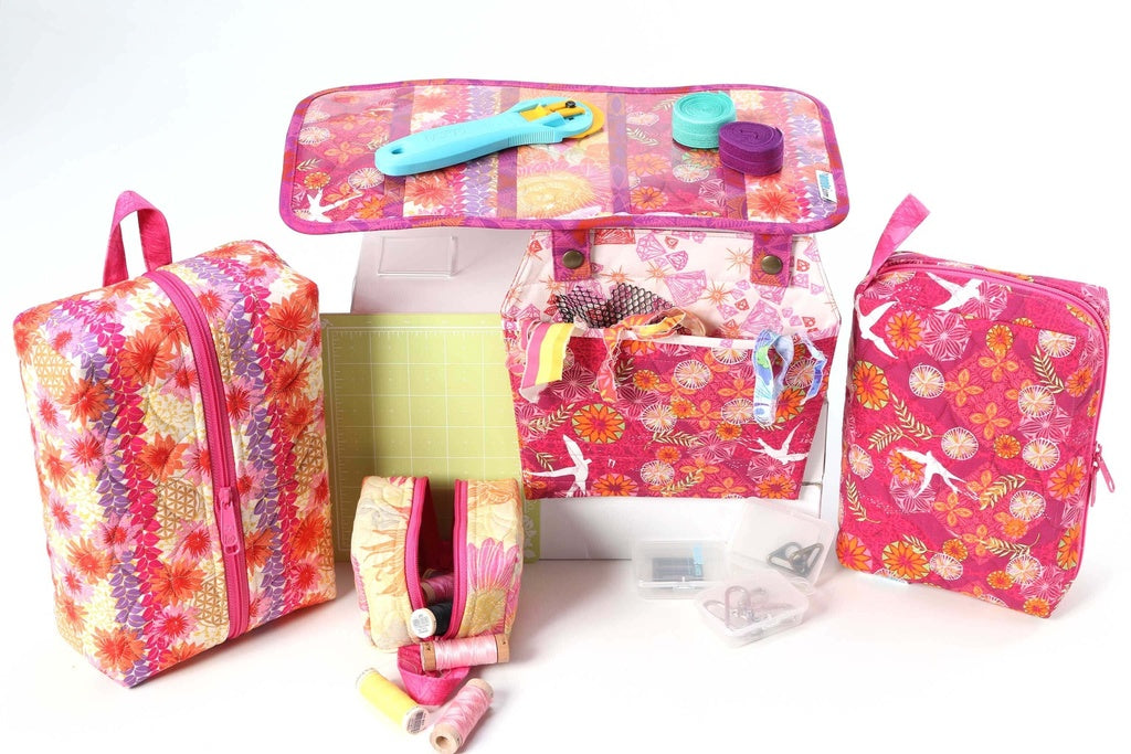 Set of colorful travel bags with various compartments on a white background