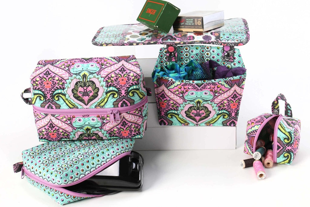 Set of colorful makeup bags with intricate patterns on a white background