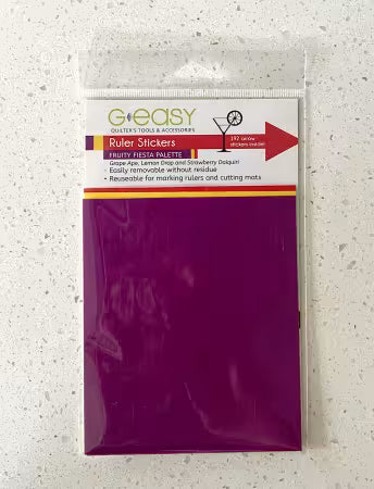Purple package of ruler stickers with a clear label on a textured white surface