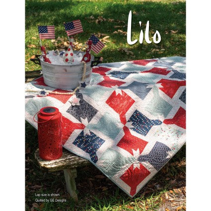 Quilt with red, white, and blue stars on a table outdoors, with 'Lilo' branding.