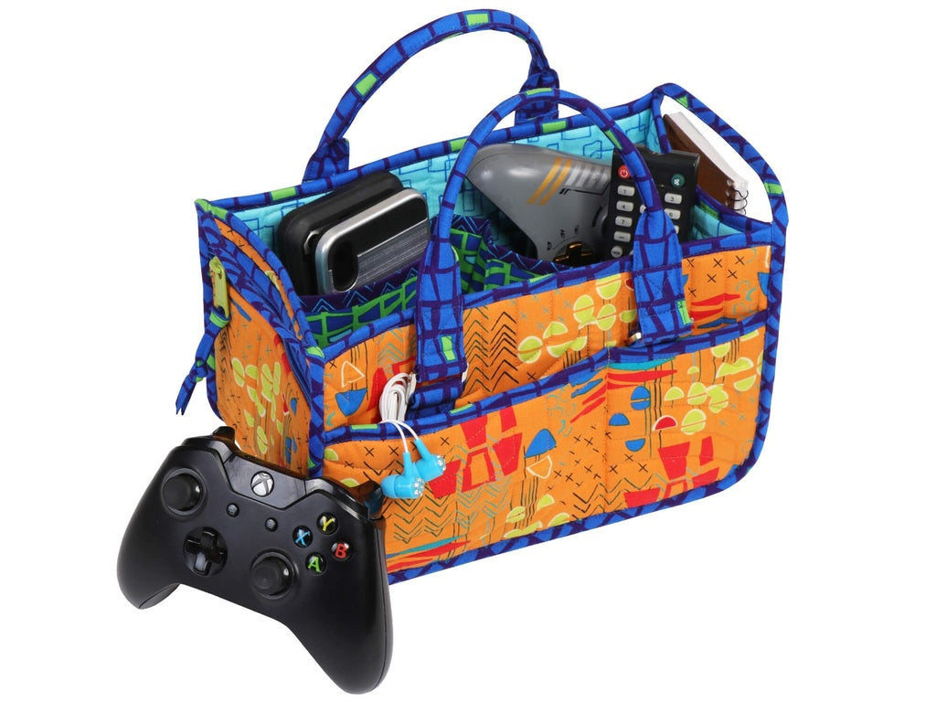 Colorful carrying case with compartments holding electronic devices on a white background