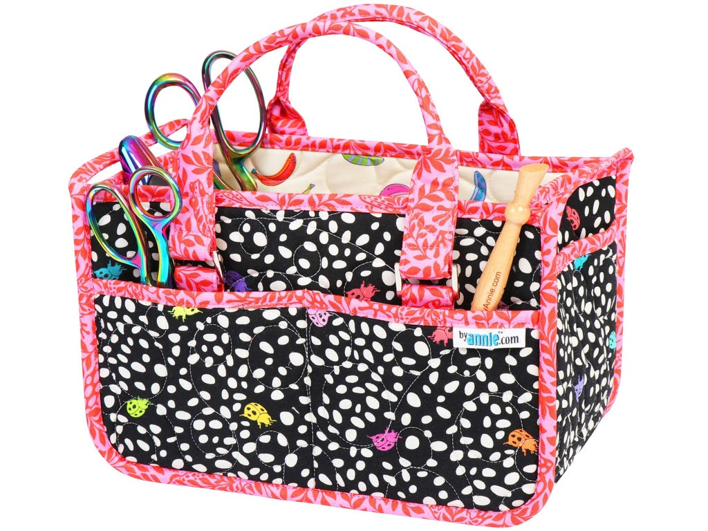 Quilted tote bag with polka dot pattern and various craft items on a white background