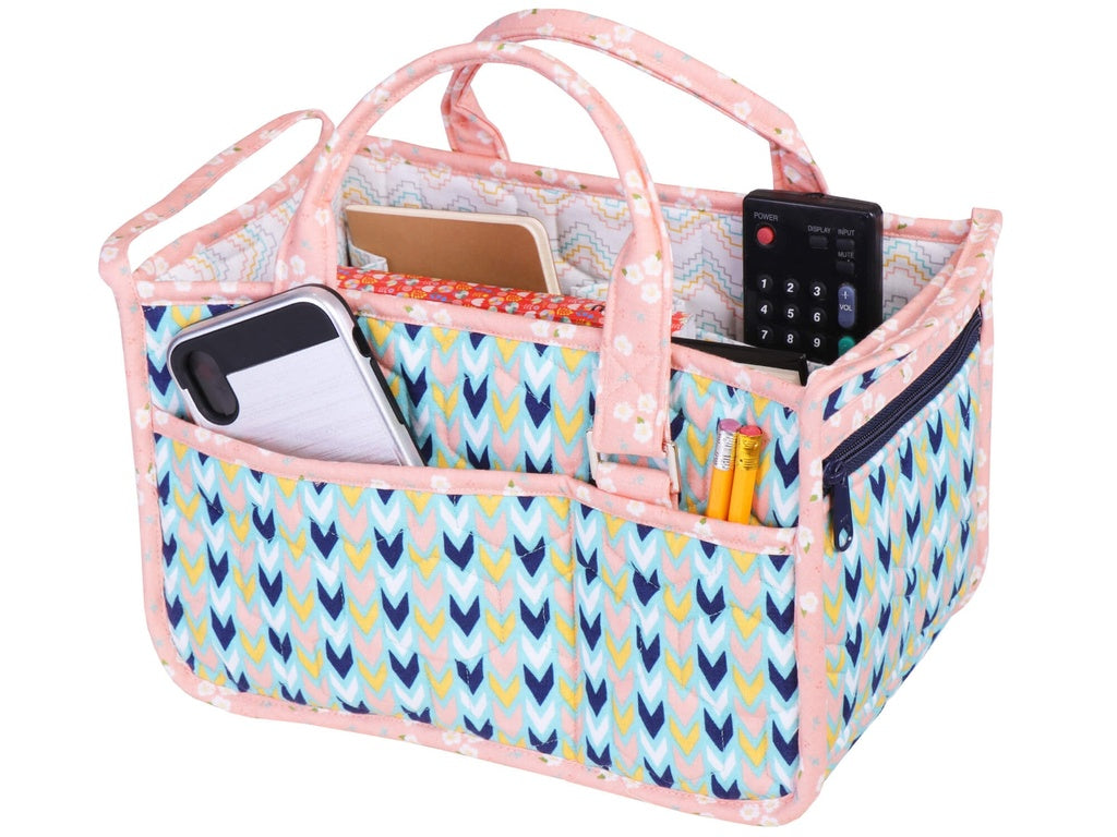 Multicolored patterned organizer with handles containing electronic devices and stationery on a white background
