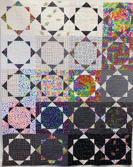 Colorful quilt with geometric pattern on a black background