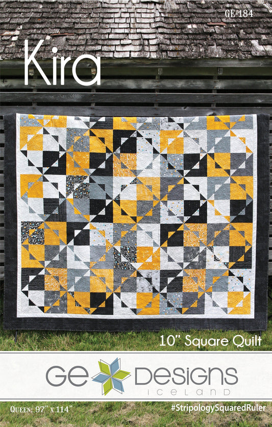 Quilt with geometric pattern on a grassy background, featuring the brand 'GE Designs'.