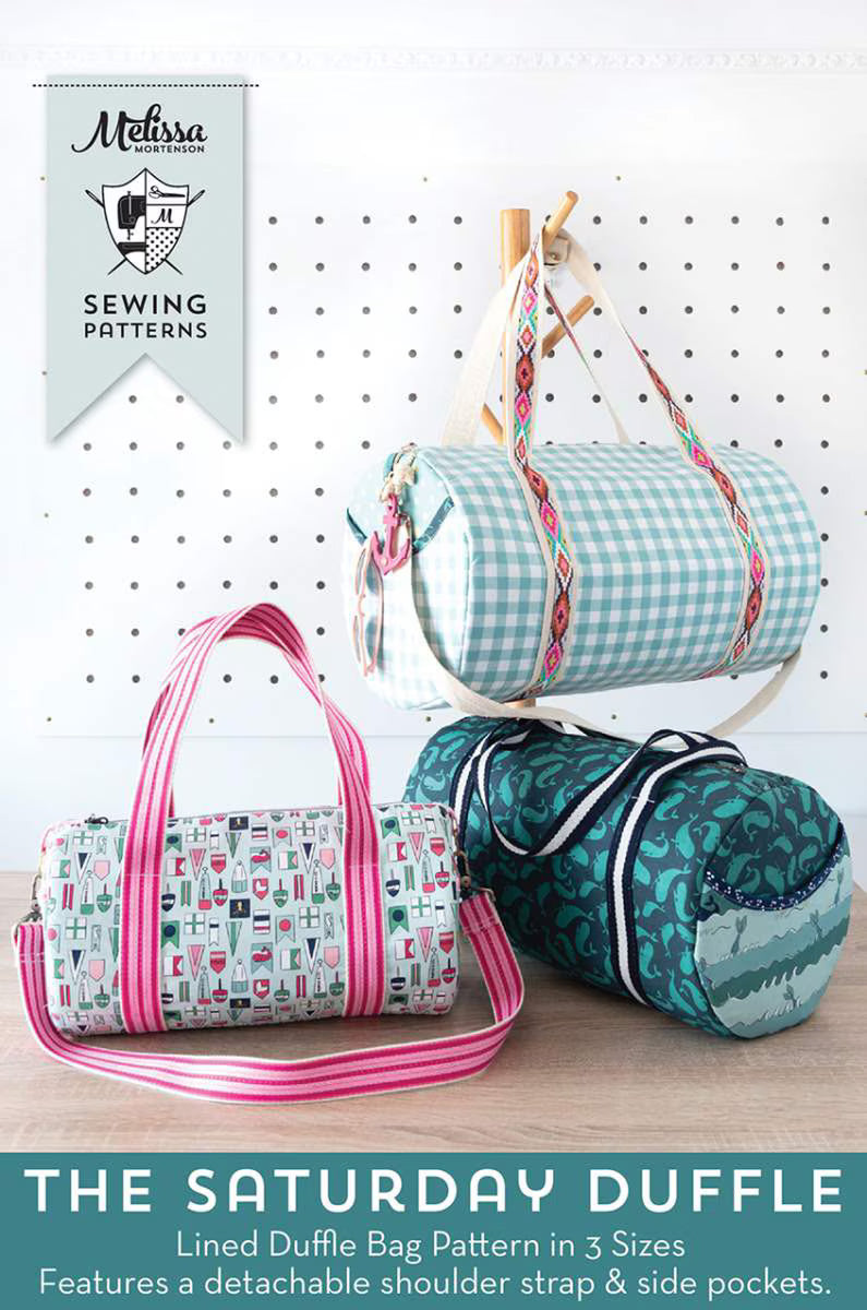 Three duffle bags with a Melissa Sewing Patterns label on a white pegboard background.