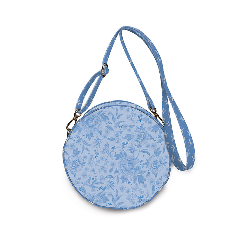 Blue floral-patterned round crossbody bag on a white background
