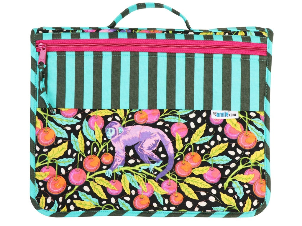 Colorful bag with monkey and fruit design on a black background