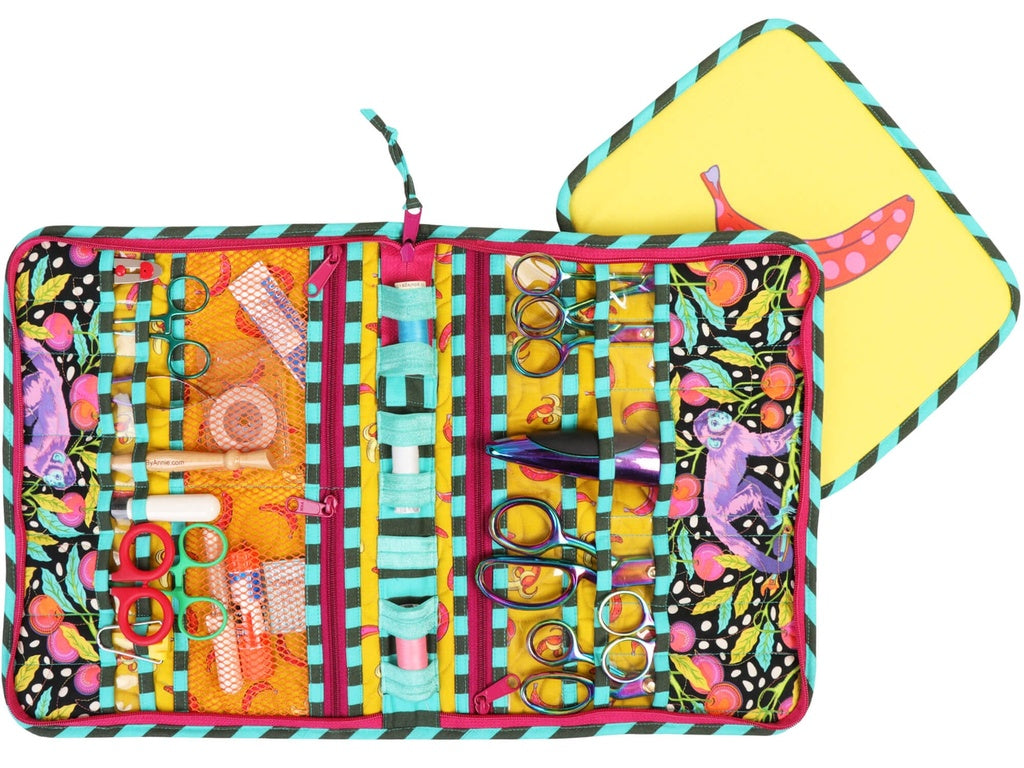 Colorful sewing kit with various tools on a white background