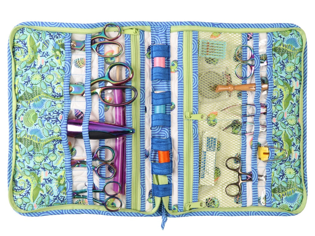 Patterned sewing kit with scissors and other tools on a white background