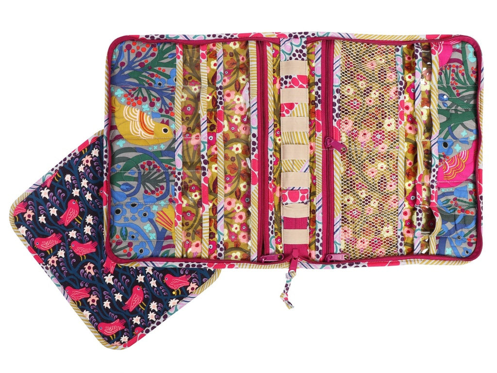 Colorful fabric roll-up organizer with various patterns on a white background