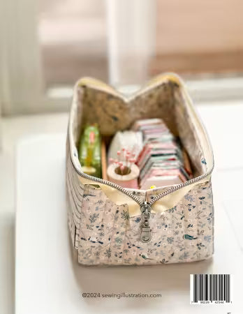 Fabric storage bin with zipper on a light surface, containing sewing supplies.