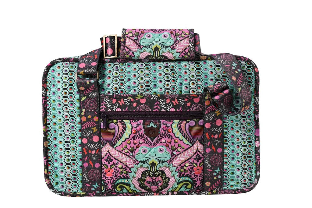 Stitcher's Suitcase sewing pattern by ByAnnie featuring a portable fabric organizer with pockets and compartments for sewing tools, notions, thread, and craft supplies. Sample