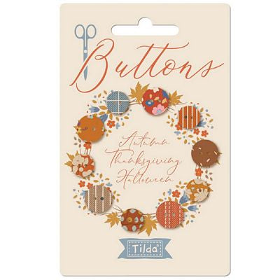 Packaging of Tilda buttons with autumn-themed design on a beige card.