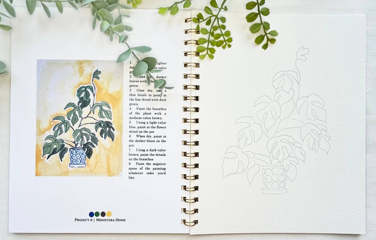 Open book with plant illustration and text, surrounded by green leaves.