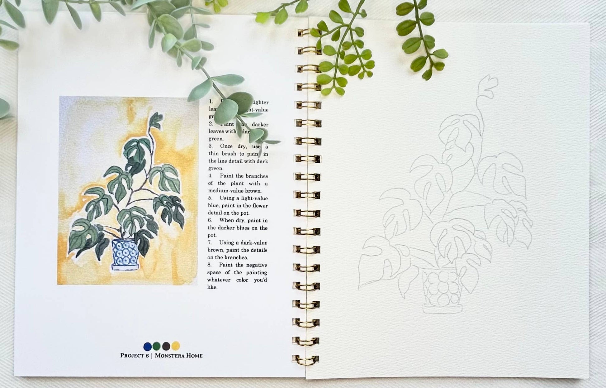 Open book with plant illustration and text, surrounded by green leaves.