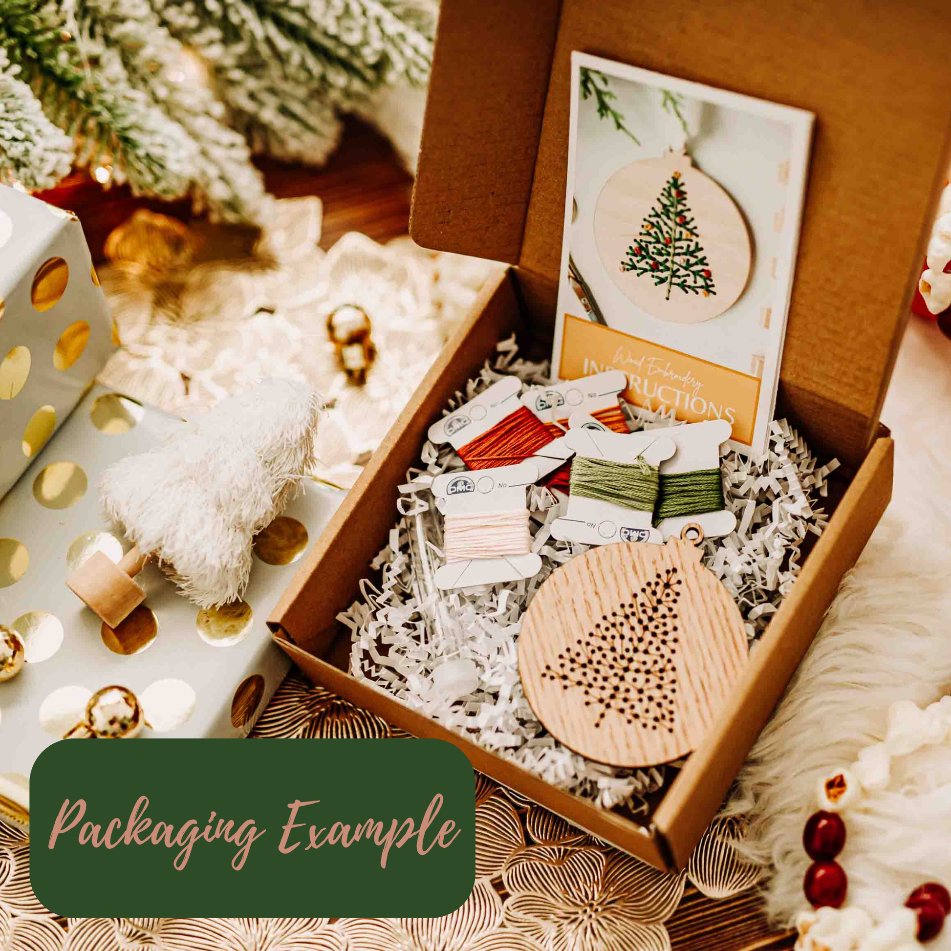 Open box containing Christmas-themed wooden ornaments and packaging materials, with a decorative background.