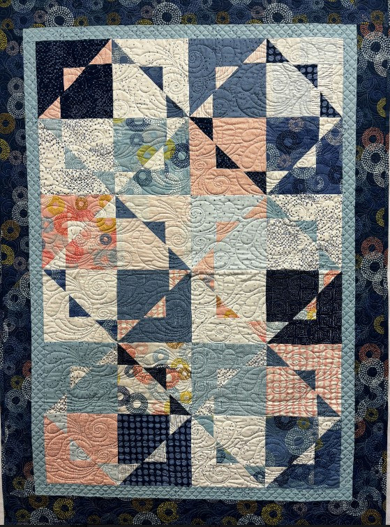 Quilt with geometric pattern on a dark blue background