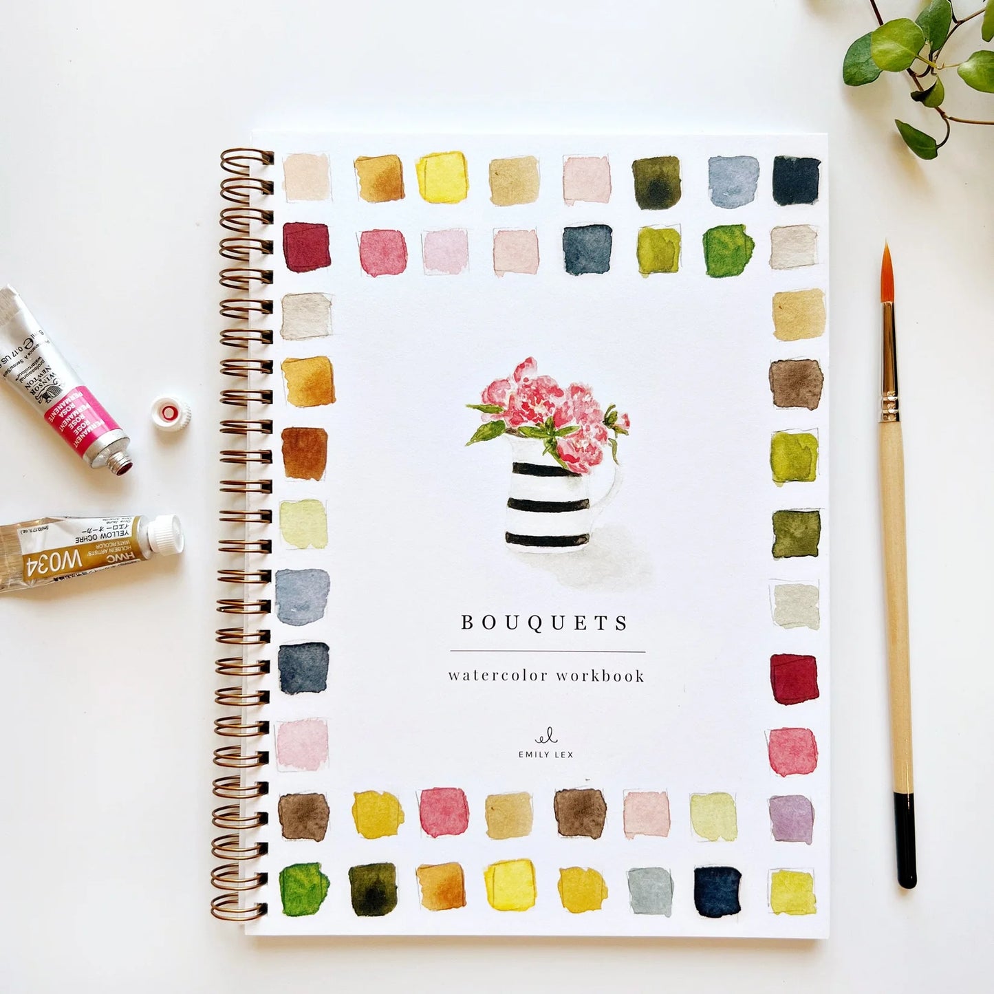 Watercolor workbook titled 'Bouquets' with color swatches and a paintbrush on a white background