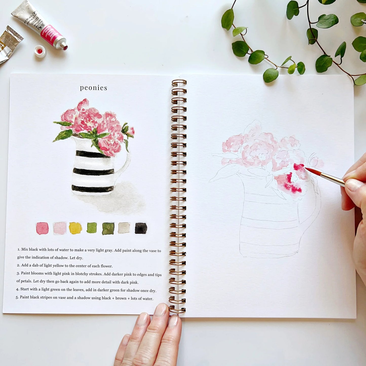 Hand paining Peonies on a jar